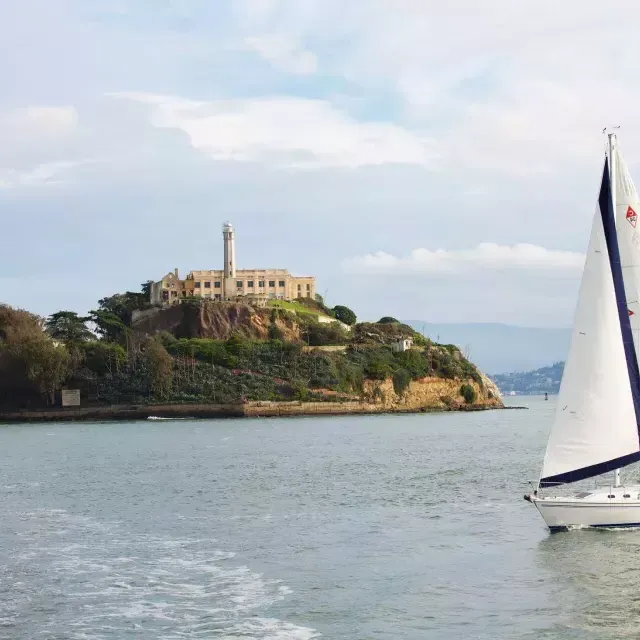 サンフランシスコのAlcatraz島の前を帆船が通過します。